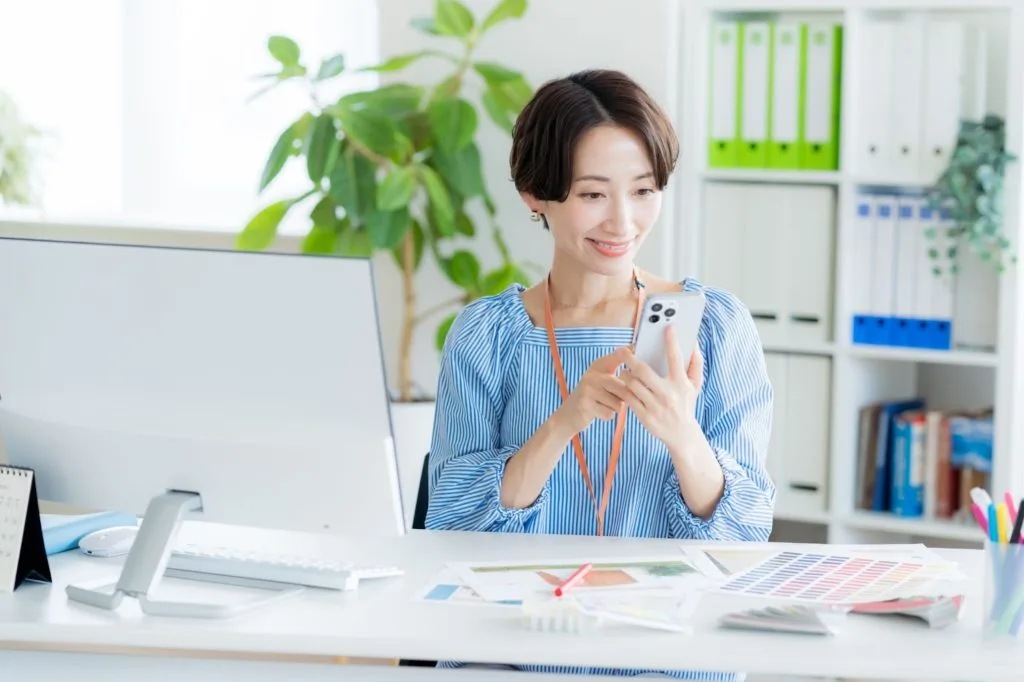 笑顔でデスクワークをする女性